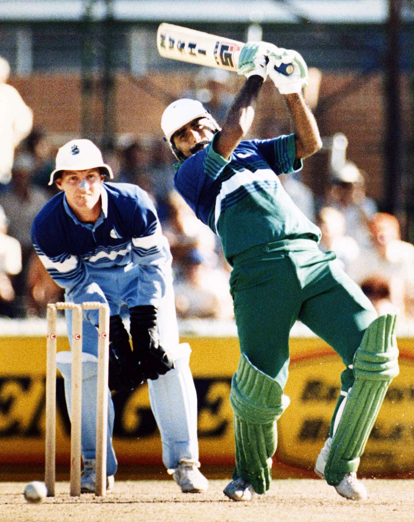 Wicketkeeper Jack Richards watches Javed Miandad make his way to 59 off 65 balls