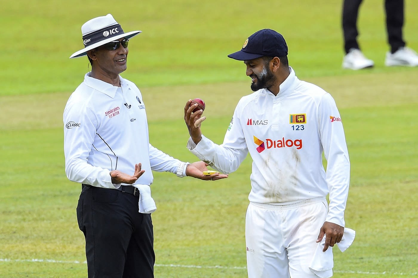 Dimuth Karunaratne speaks with umpire Ruchira Palliyaguruge