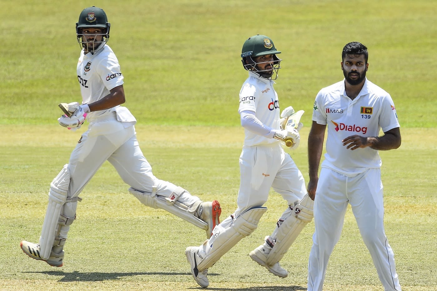 Najmul Hossain Shanto and Mominul Haque run between the wickets as Lahiru Kumara looks on