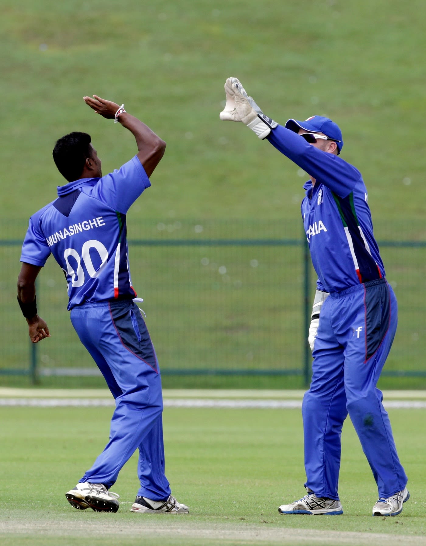Gayashan Munasinghe of Italy celebrates a wicket with wicketkeeper Andy Northcote