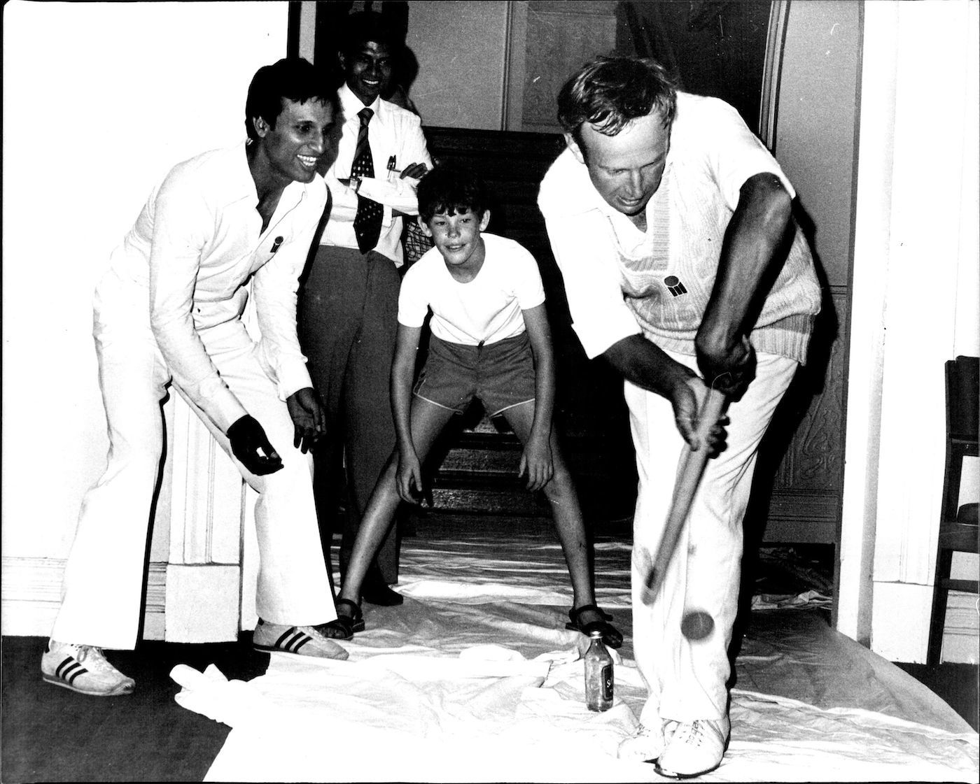 Asif Iqbal, James Packer and Derek Underwood, get in a game of hallway cricket while rain stops play outside