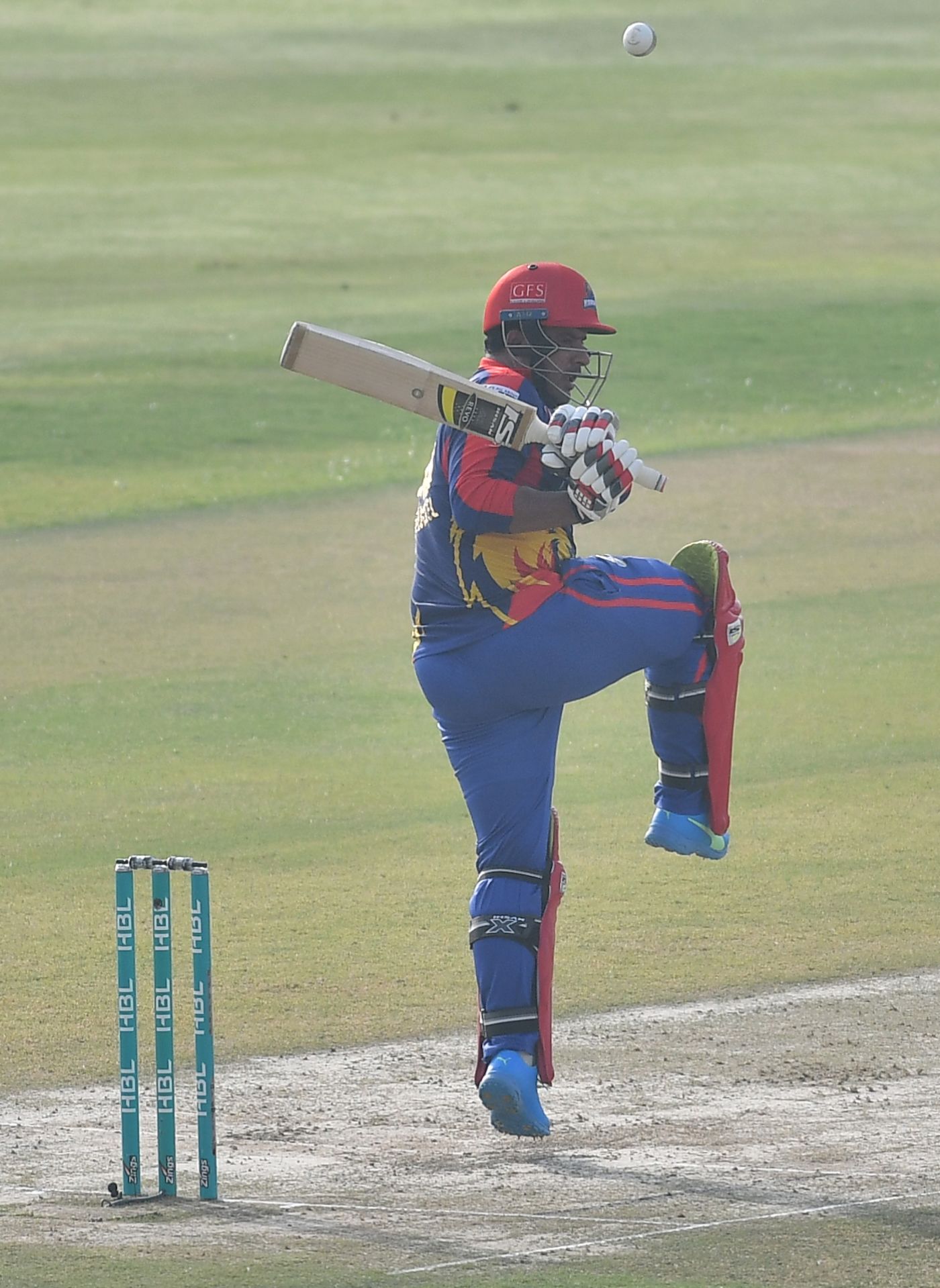 Sharjeel Khan goes on one leg to tackle the ball
