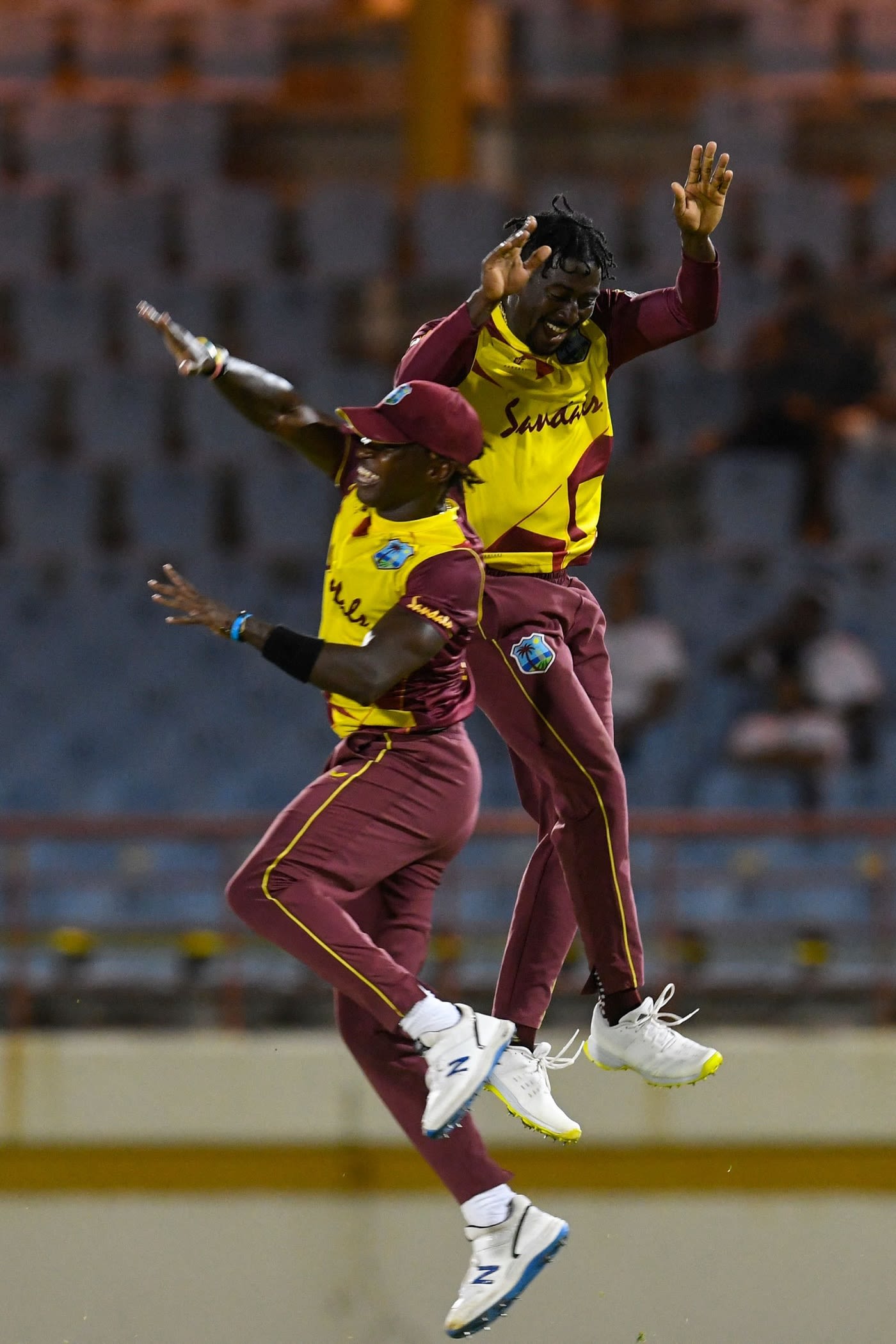 Hayden Walsh Jr. and Fidel Edwards celebrate a wicket