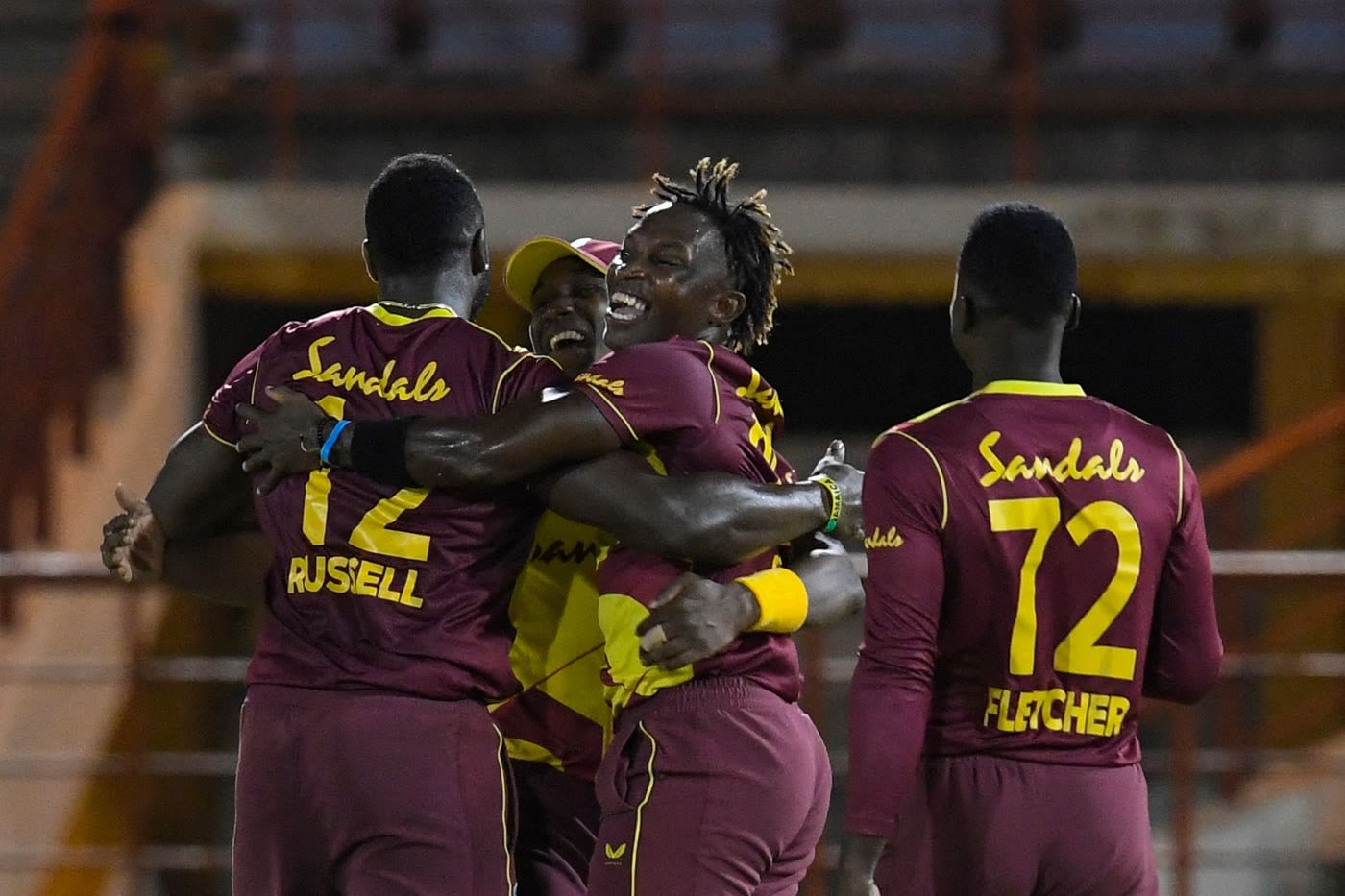 Fidel Edwards is mobbed by his team-mates