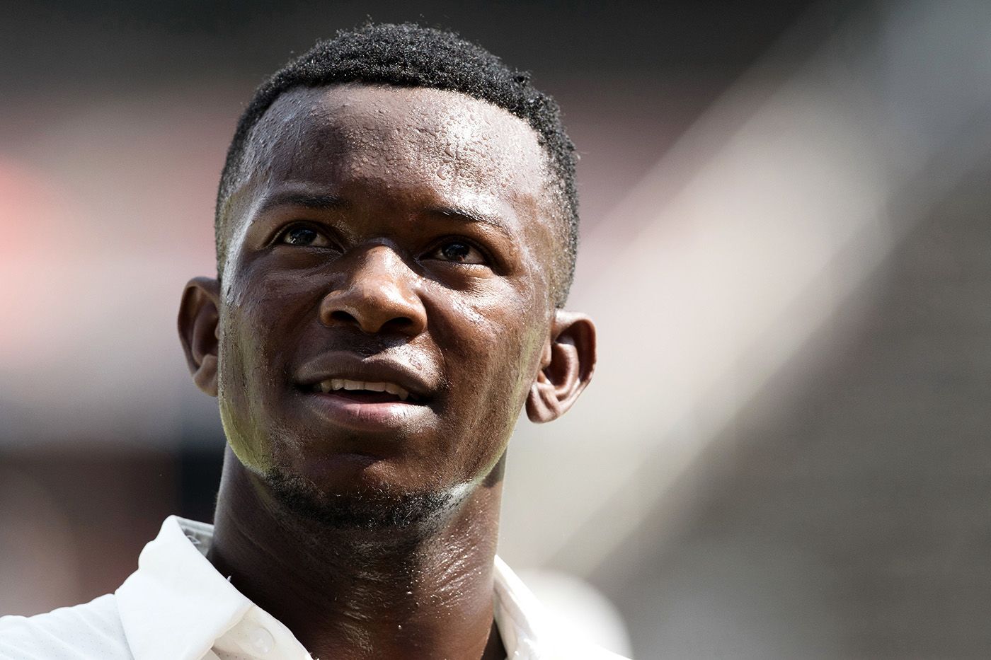 Carl Mumba smiles after getting his maiden Test wicket