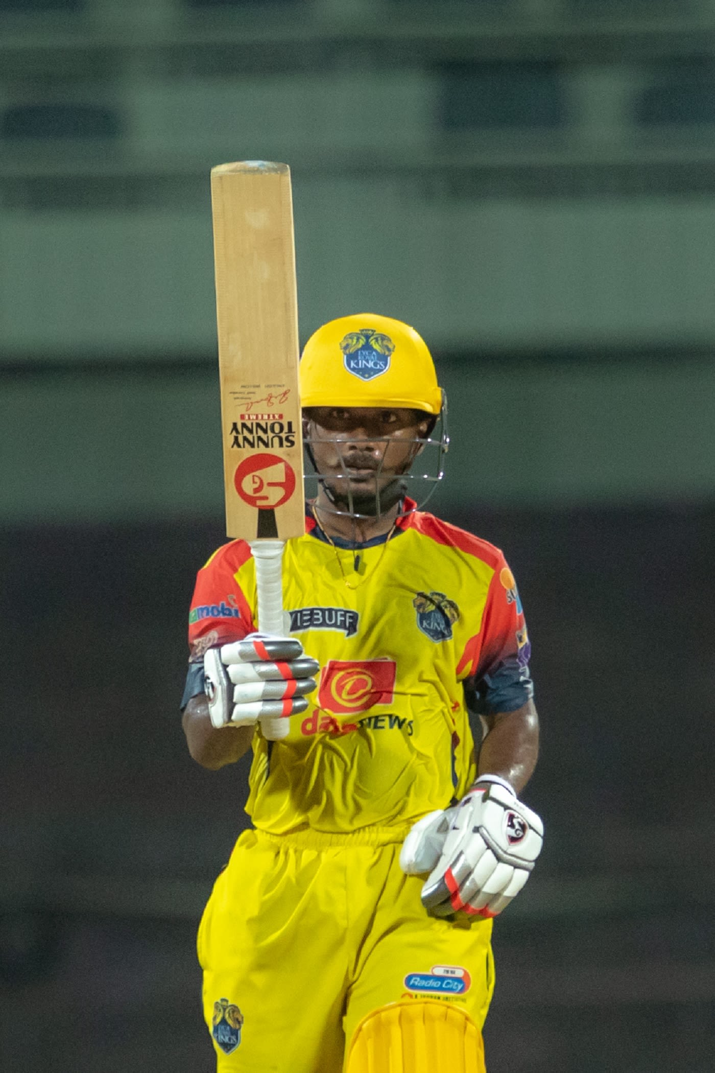 GS Raju raises his bat after getting to a fifty