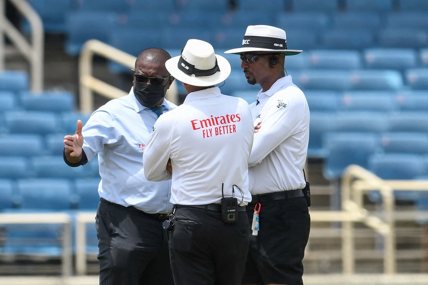 Match referree Richie Richardson discusses the ground condition with umpires Joel Wilson and Gregory Brathwaite