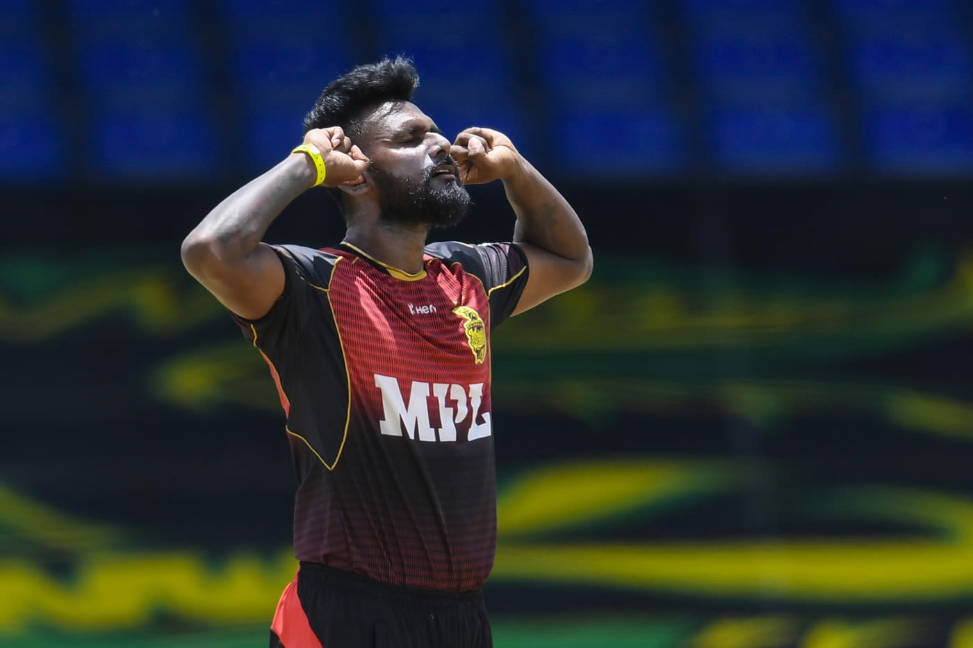 Isuru Udana with his trademark 'I can't hear you' hands in ears wicket celebration