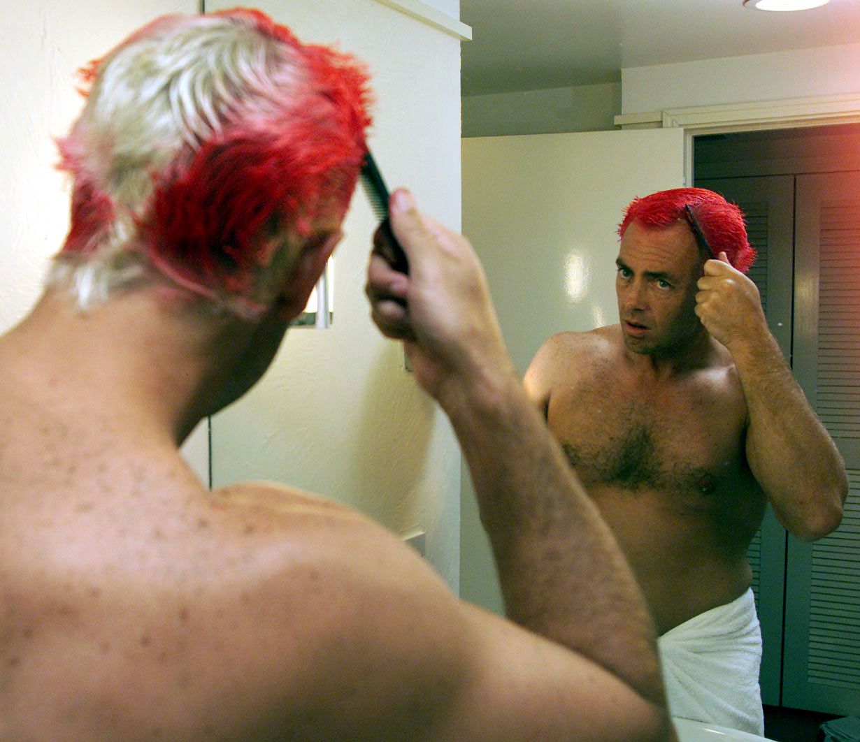 Colin Miller dyes his hair in his hotel room