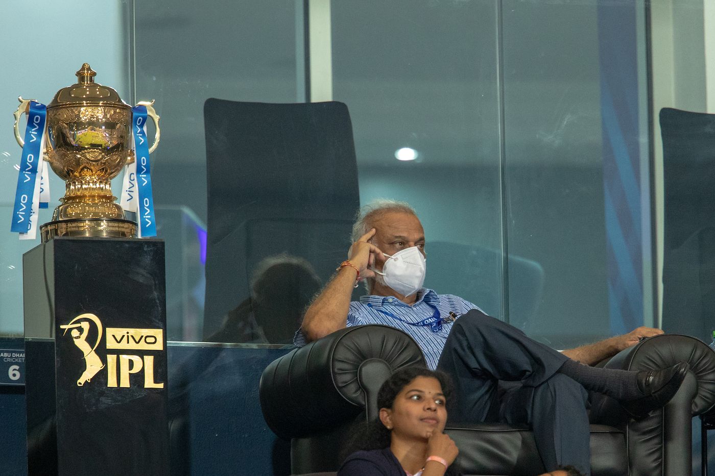 IPL chairman Brijesh Patel watches the match with the IPL trophy not far from him