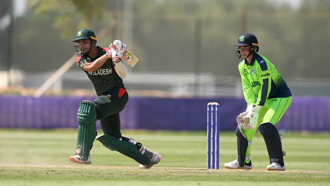 Nurul Hasan plays on the leg side as Neil Rock looks on