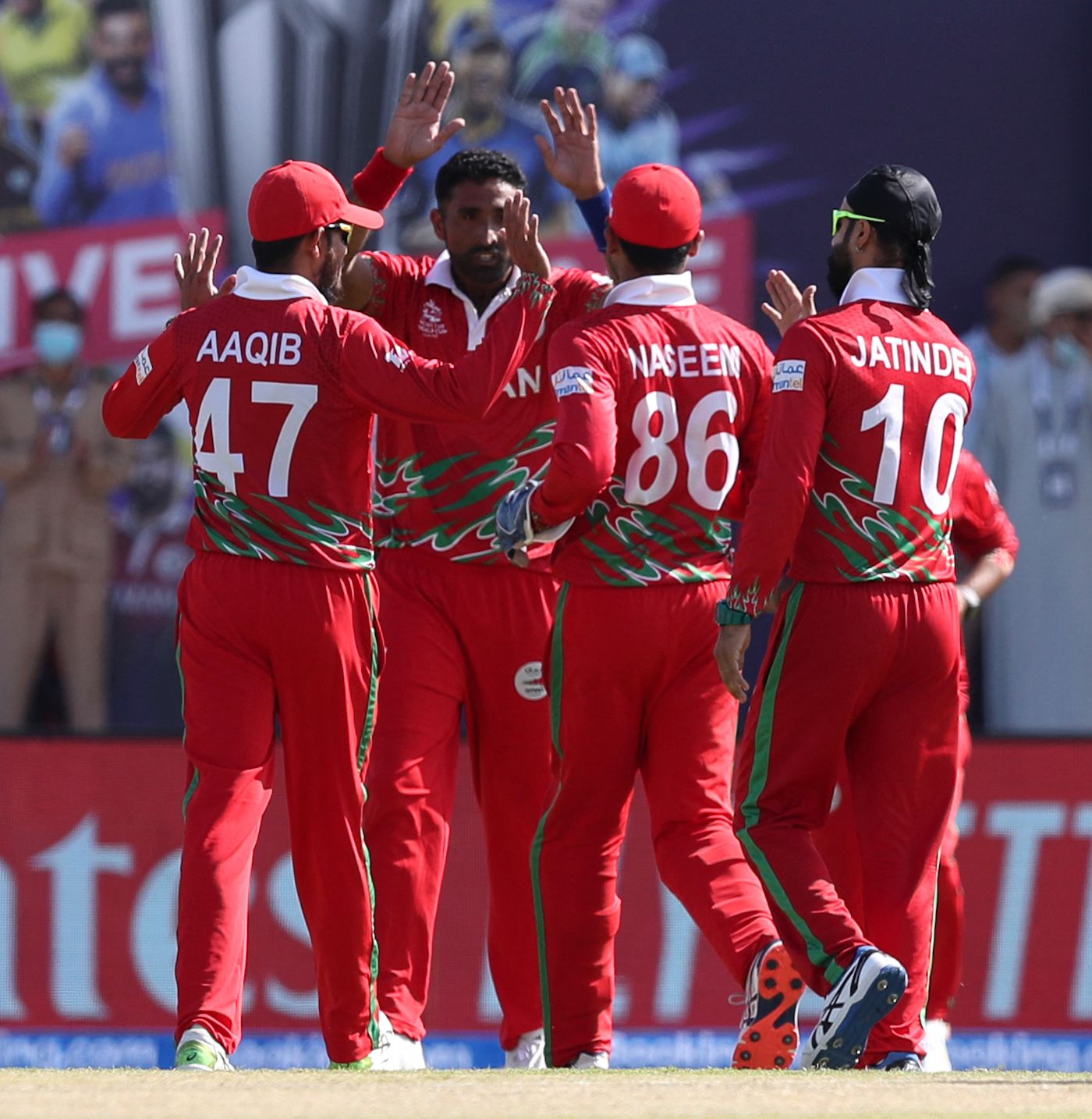 Kaleemullah celebrates a wicket with his team-mates