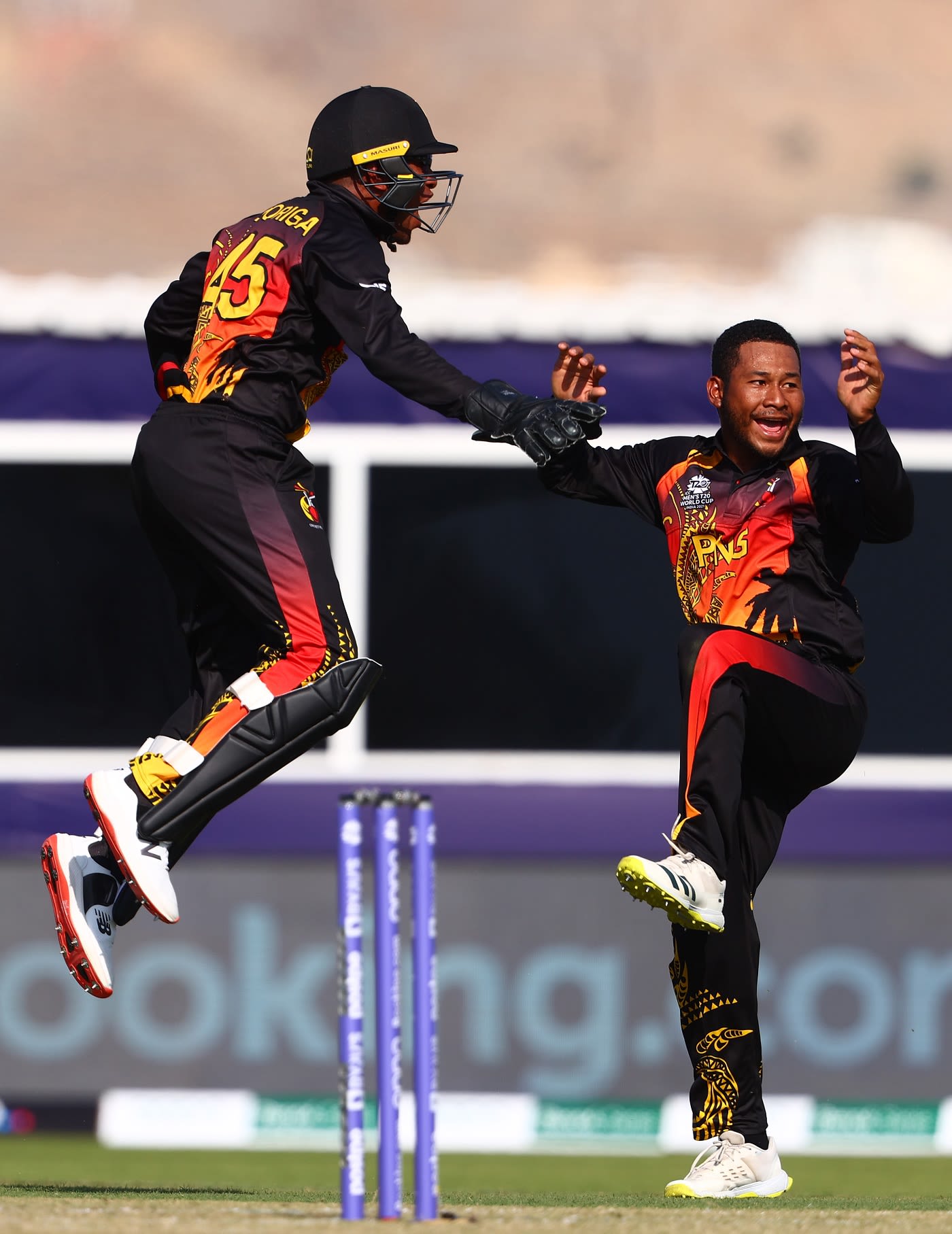 Kiplin Doriga and Simon Atai leap in joy after the latter dismissed Matthew Cross