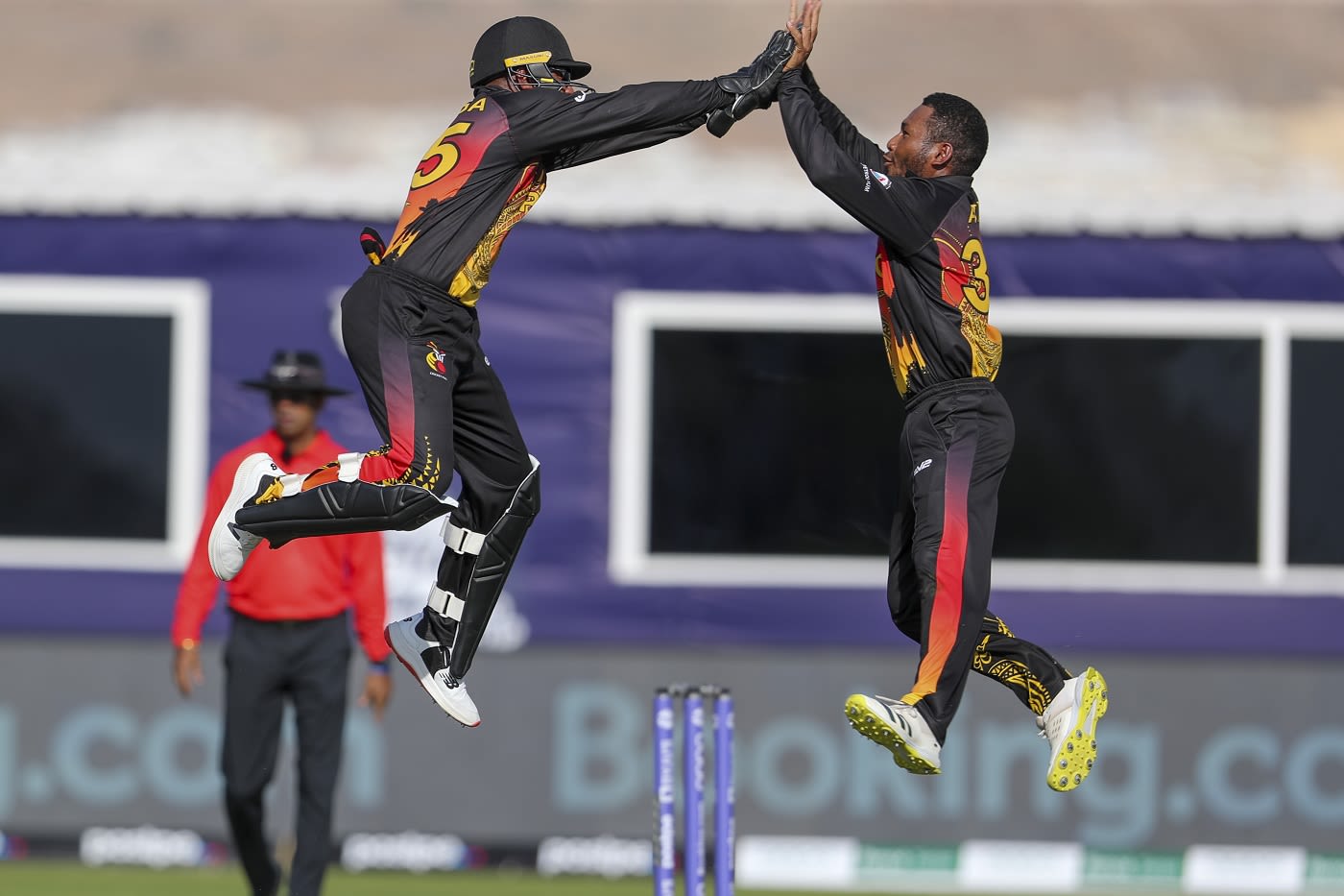 Kiplin Doriga and Simon Atai celebrate a wicket