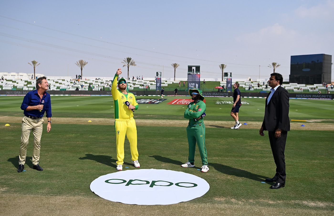 Mark Nicholas, Temba Bavuma and Javagal Srinath watch as Aaron Finch flips the coin