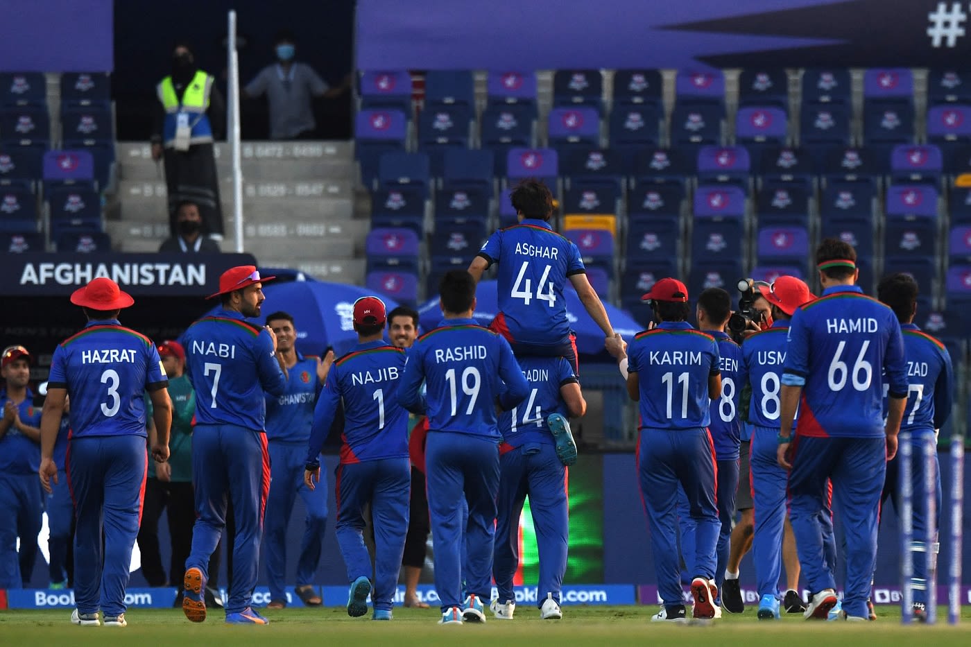 Asghar Afghan is carried by his team-mates after his final game
