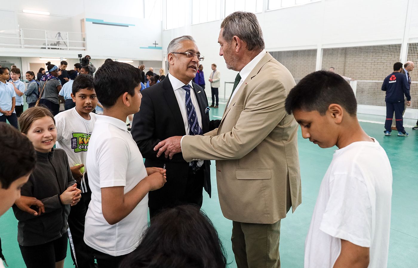 Lord Patel of Bradford speaks with Graham Gooch at an event at Leyton Cricket Club