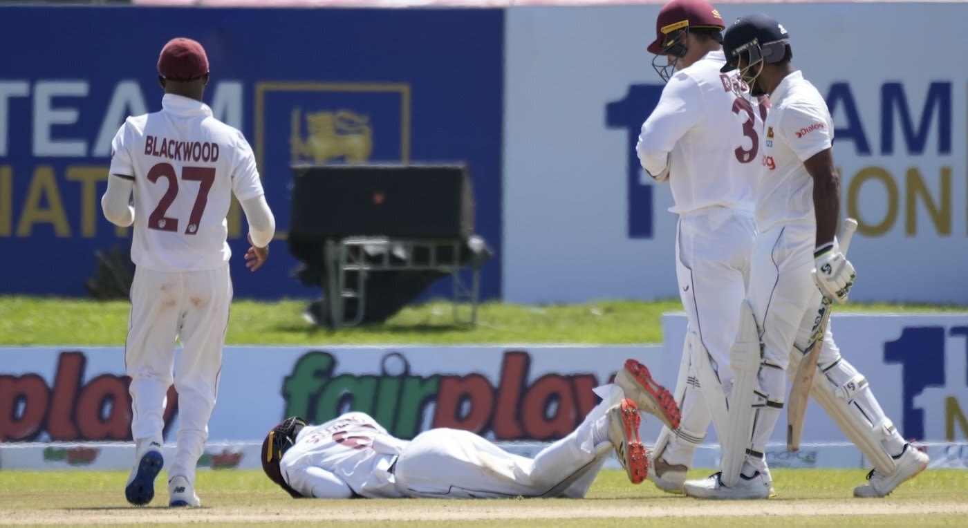 Jeremy Solozano is down on the ground after being hit on the head by a pull shot from Dimuth Karunaratne