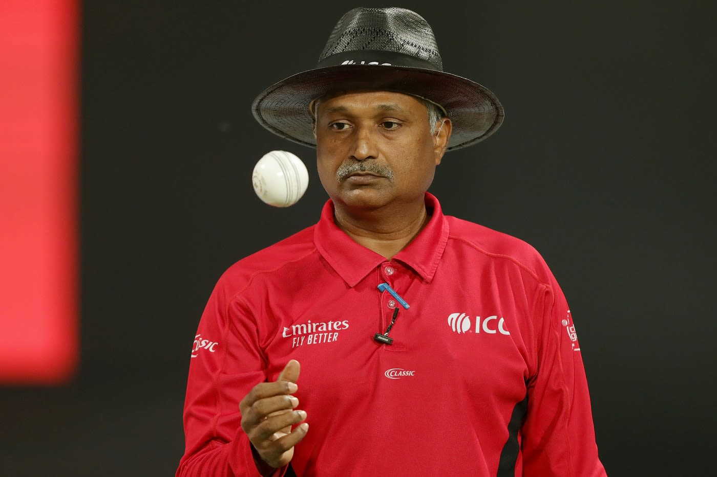 Umpire KN Ananthapadmanabhan tosses the ball up