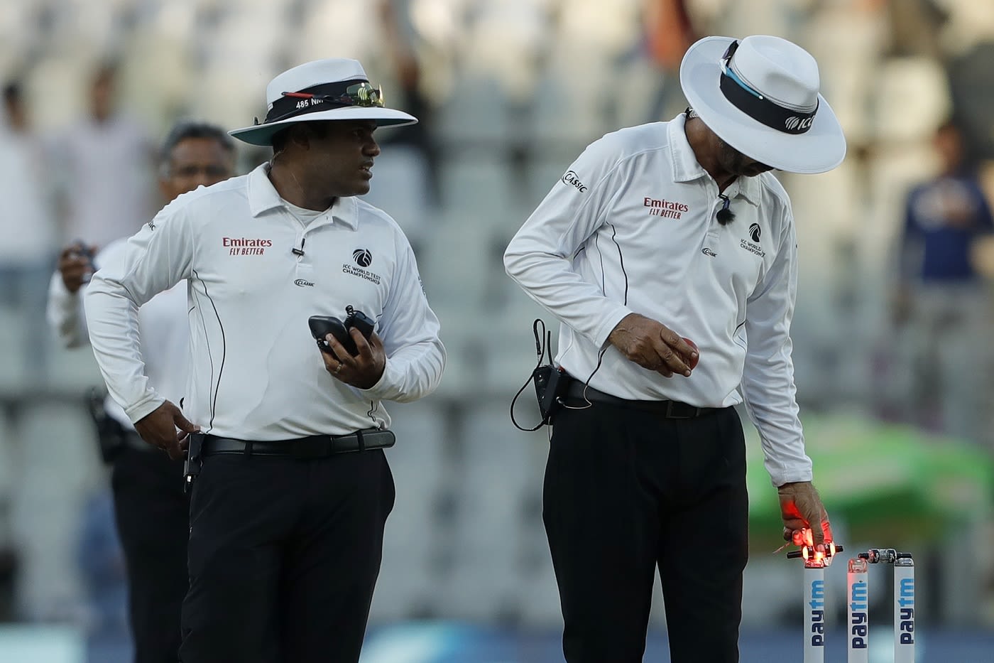 Umpires Nitin Menon and Anil Chaudhary walk off at stumps