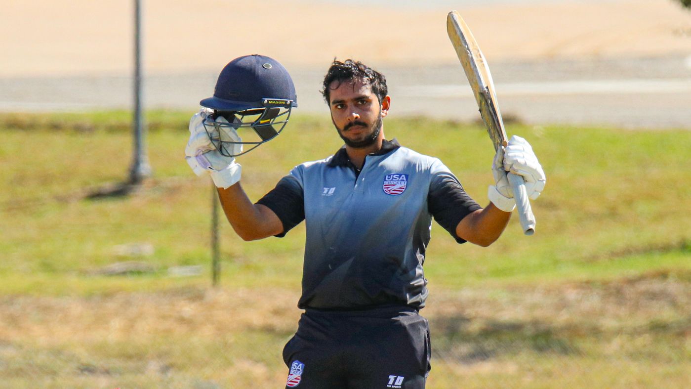 Rahul Jariwala raises his bat after reaching a century for USA U19