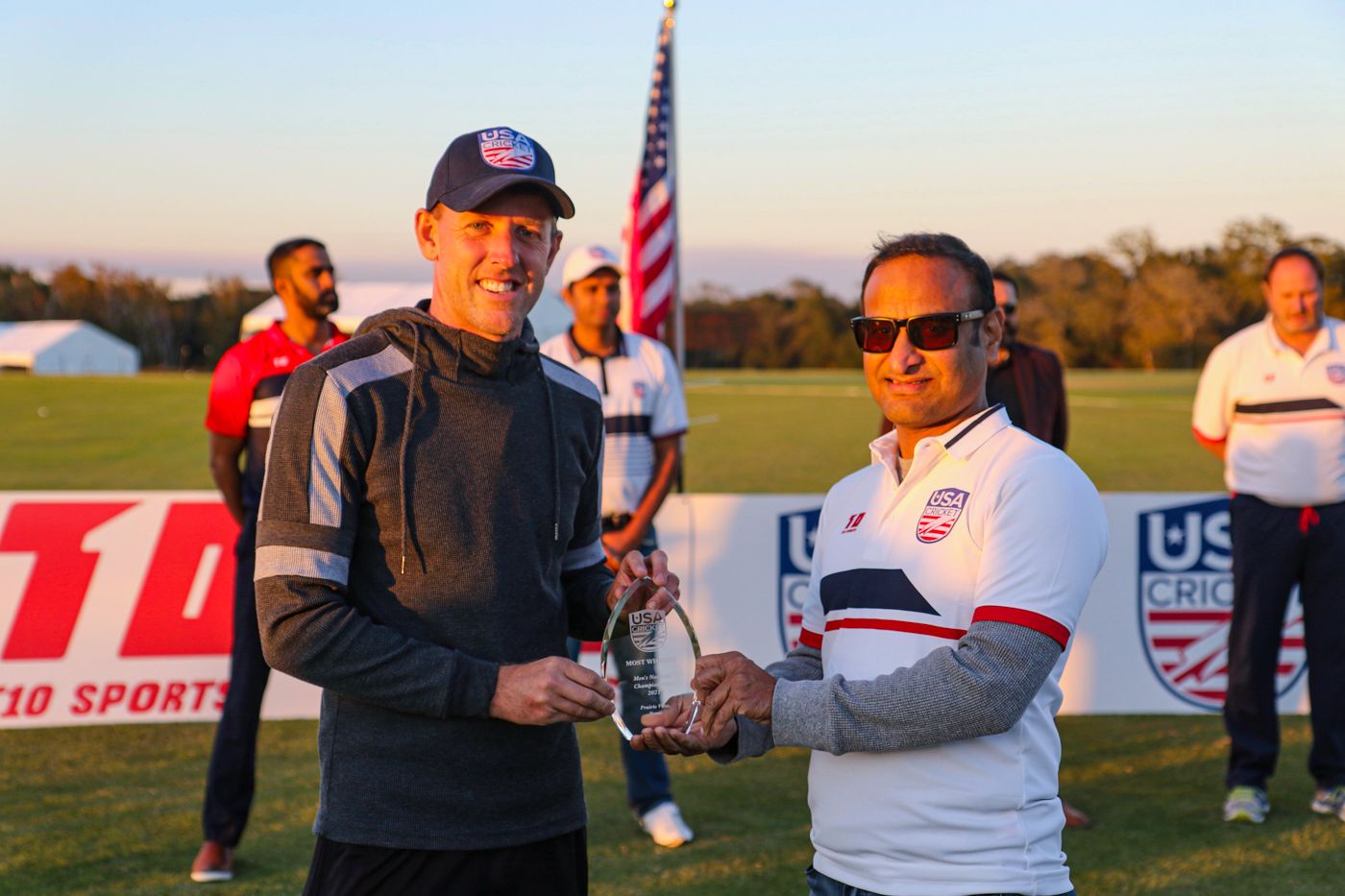 Marty Kain accepts the award for most wickets from USA Cricket board member Venu Pisike
