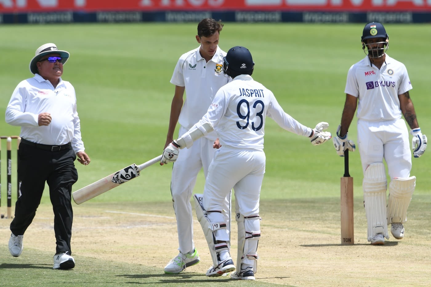 Umpire Marais Erasmus runs in as Jasprit Bumrah and Marco Jansen get embroiled in a mid-pitch confrontation