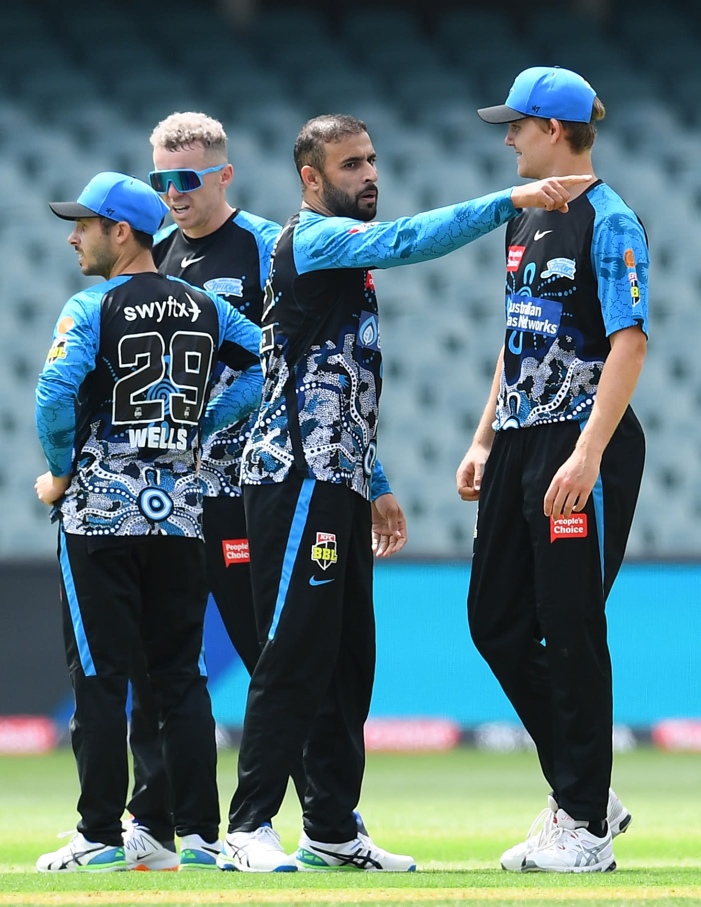 Fawad Ahmed gets together with his team-mates after dismissing Jason Behrendorff
