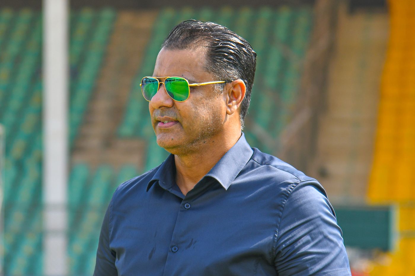 Waqar Younis watches the players prepare from the sidelines