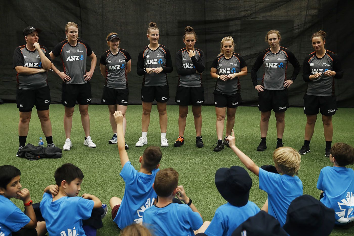 Rachel Priest, Maddy Green, Katie Perkins, Rosemary Mair, Amelia Kerr, Leigh Kasperek, Anna Peterson and Hayley Jensen take questions from kids during a coaching clinic