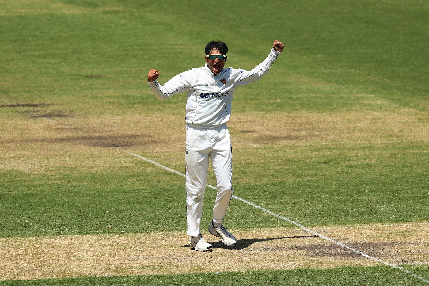 Nivethan Radhakrishnan celebrates his maiden first-class wicket on debut