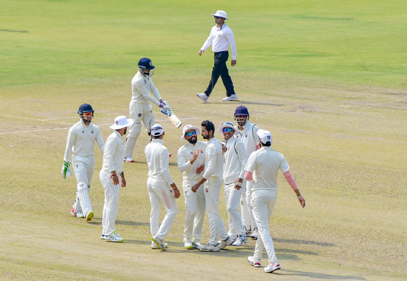 Vikas Mishra is mobbed by his team-mates