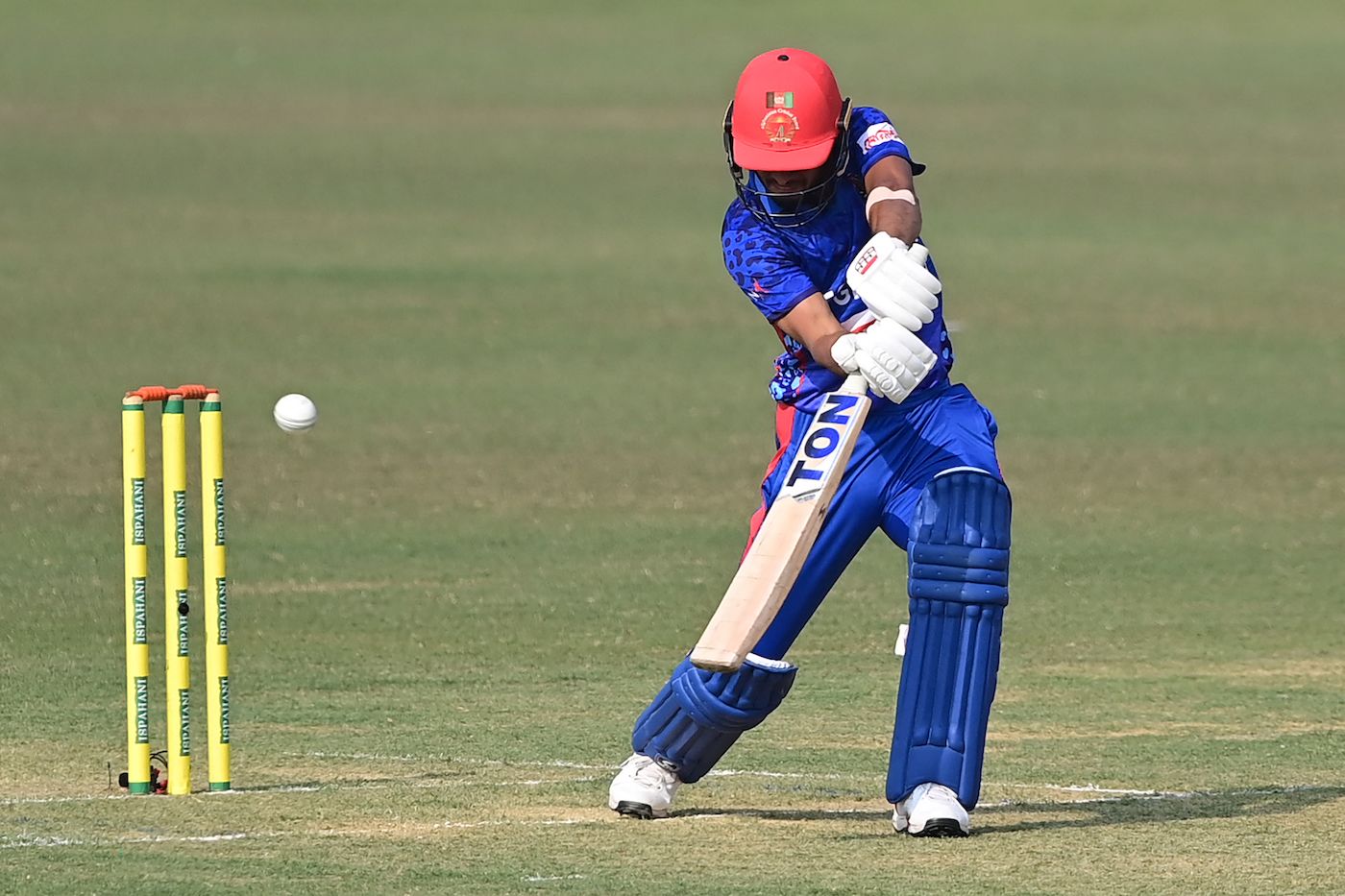 Riaz Hassan opens the face of his bat as he drives on the off side