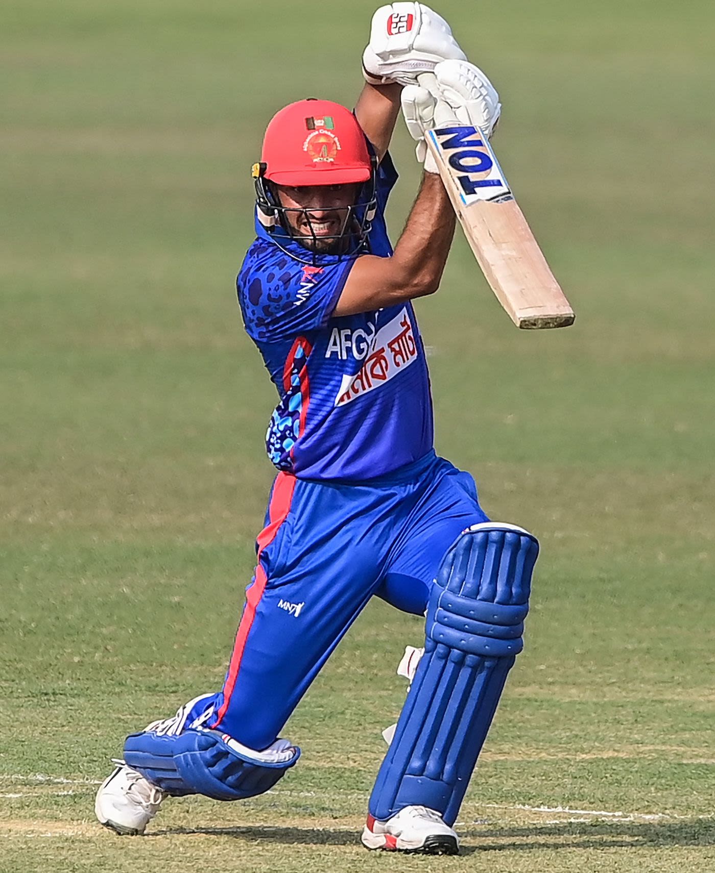 Riaz Hassan strikes a neat pose as he drives down the ground