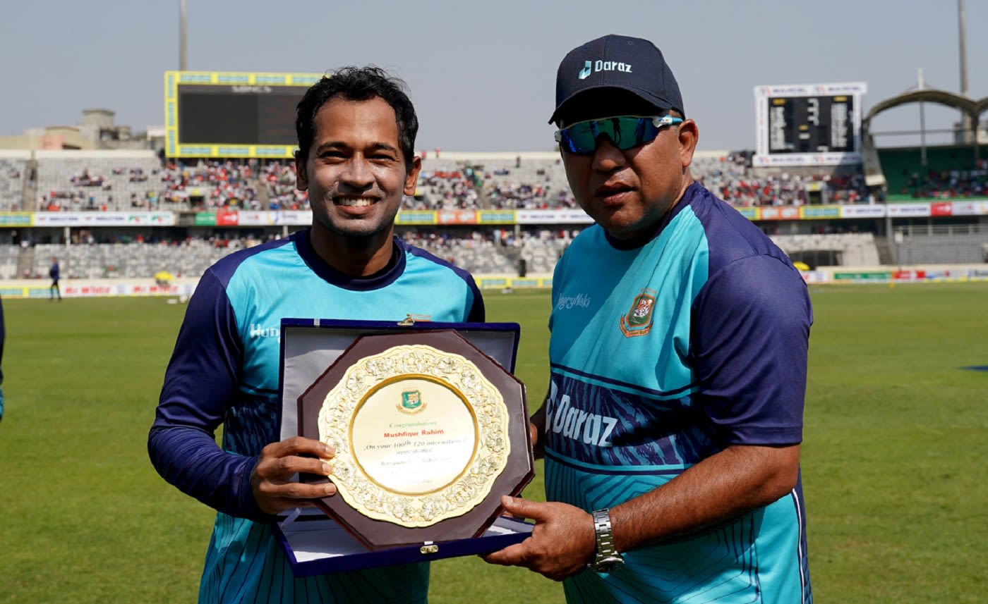 Mushfiqur Rahim receives a crest from Khaled Mahmud, the Bangladesh team director, ahead of his 100th T20I