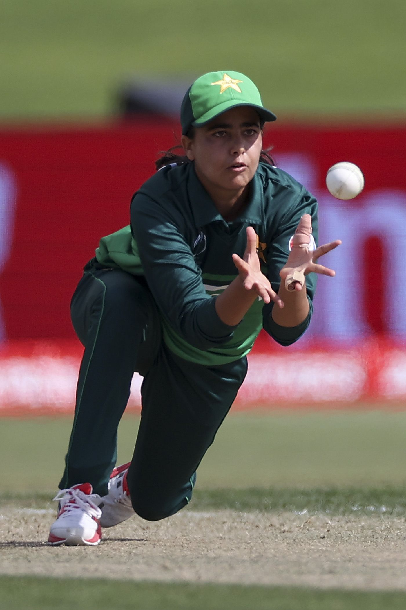 Ghulam Fatima dives forward to catch Laura Wolvaardt off her own bowling