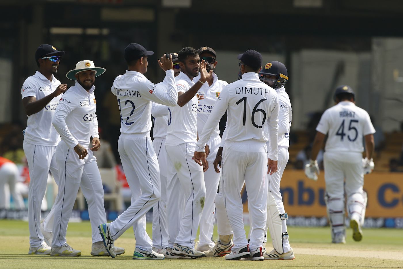 Lasith Embuldeniya is congratulated by his team-mates after dismissing Rohit Sharma