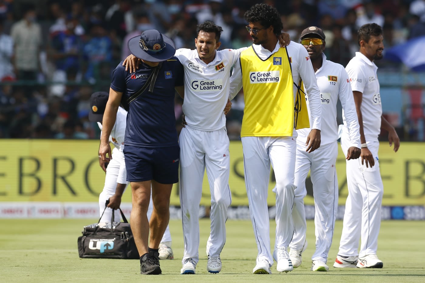 Praveen Jayawickrama walks off the field after injuring his ankle
