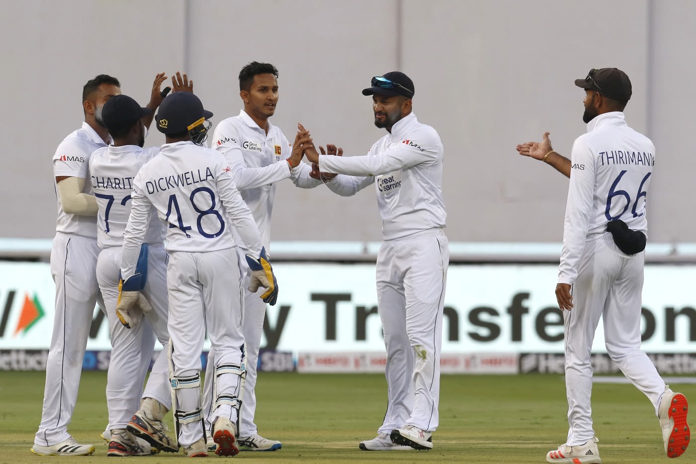 Praveen Jayawickrama is congratulated by his team-mates