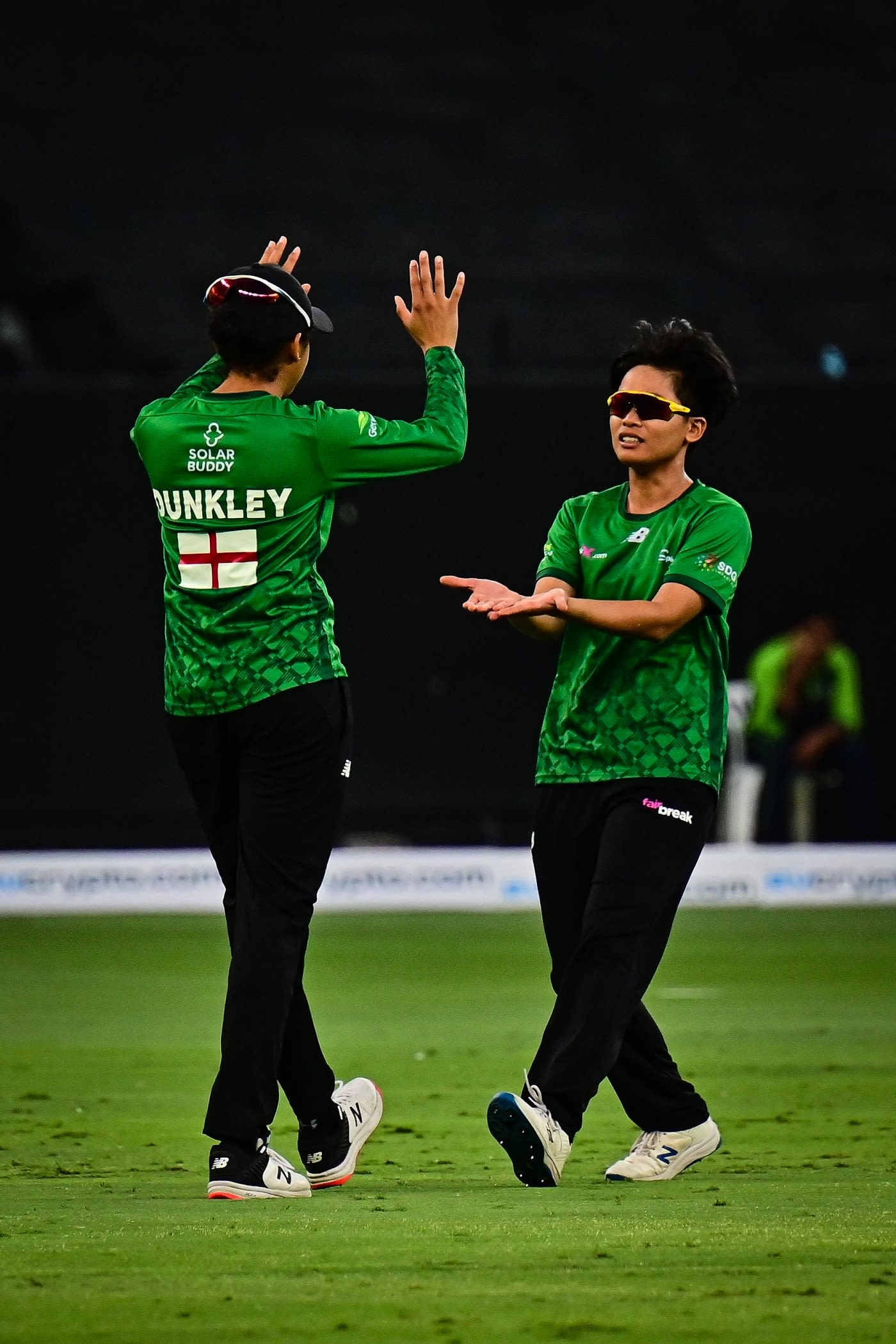 Nattaya Boochatham celebrates a wicket with Sophia Dunkley