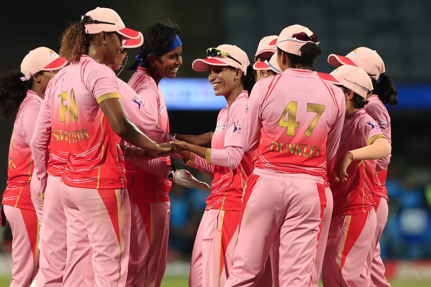 Salma Khatun (middle, smiling with cap on) celebrates a wicket