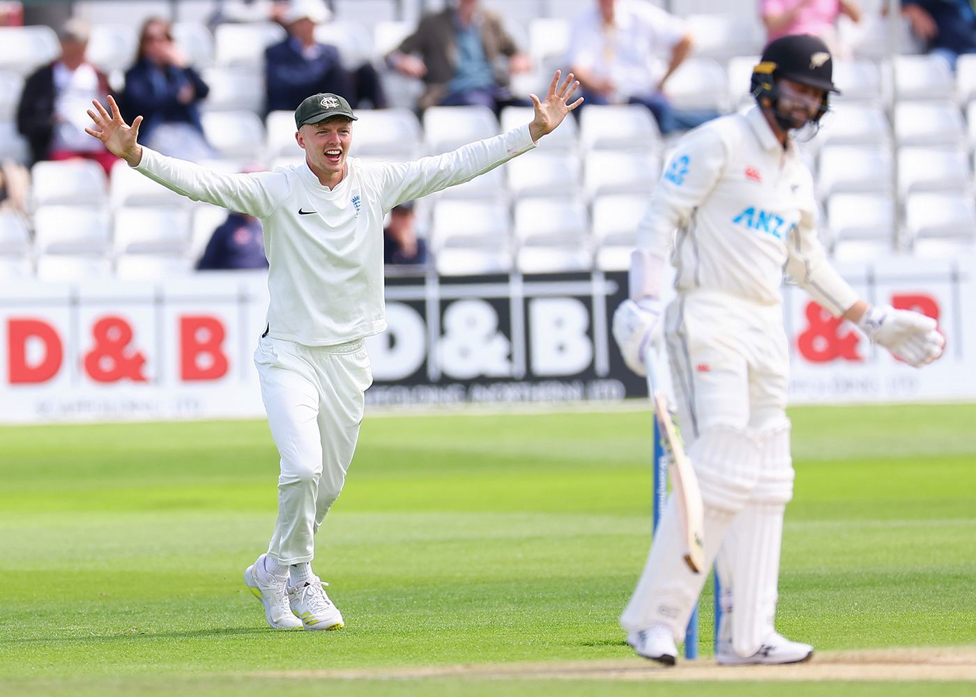 Lyndon James celebrates the wicket of Devon Conway
