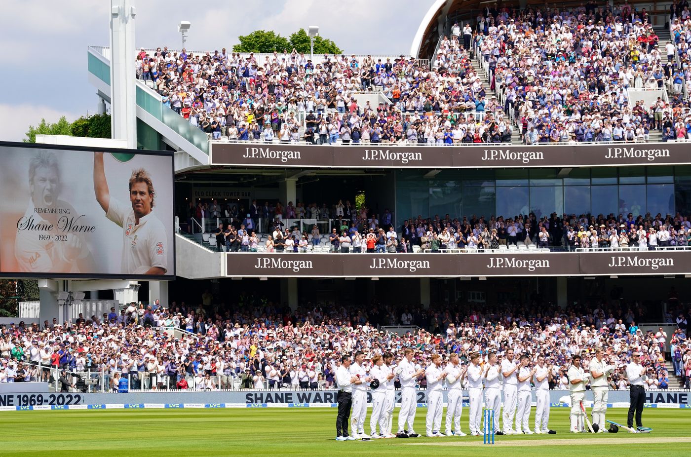 The players and officials line up to applaud the late Shane Warne for 23 seconds at the end of the 23rd over