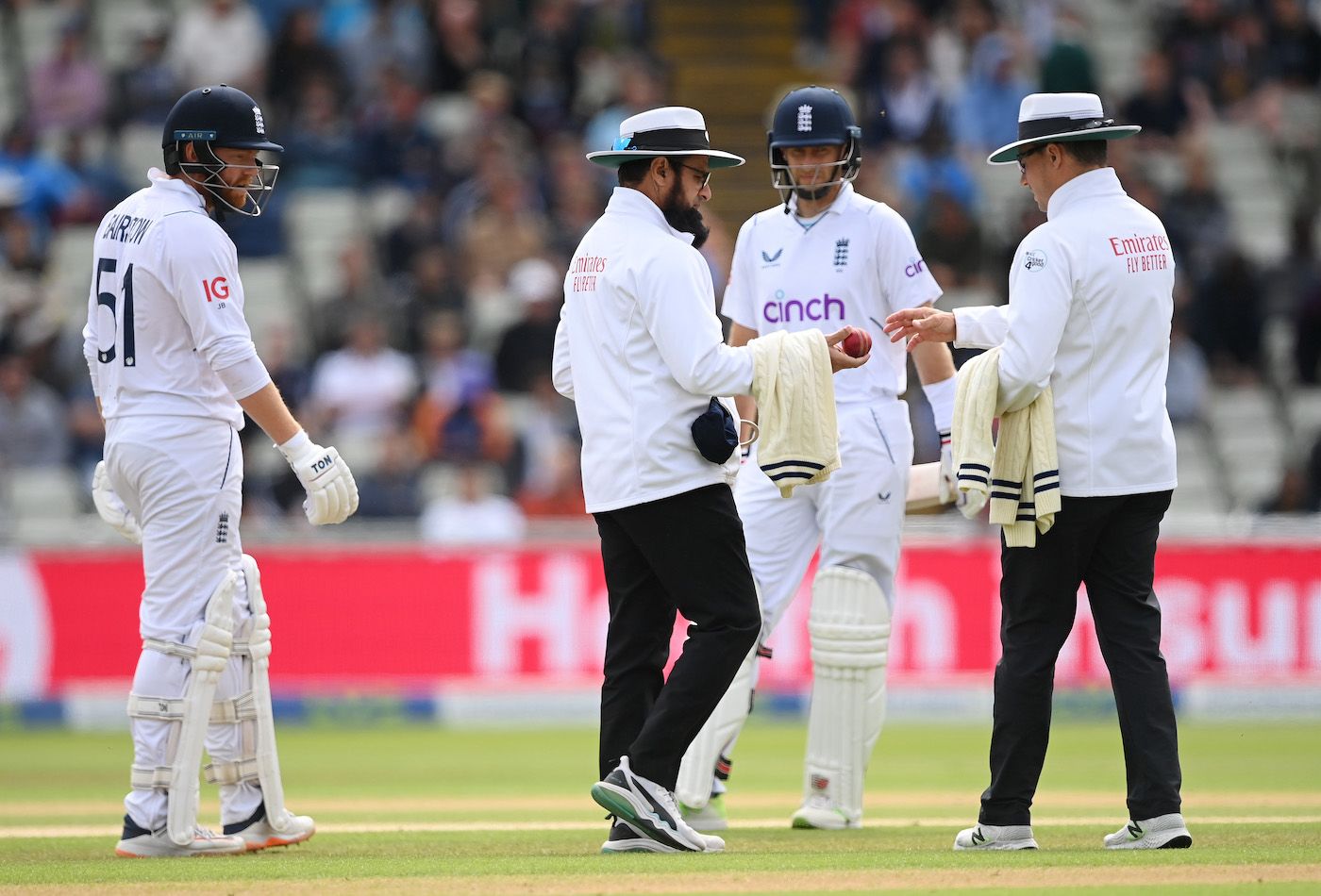 Jonny Bairstow and Joe Root watch as umpires Aleem Dar and Richard Kettleborough check the condition of the ball