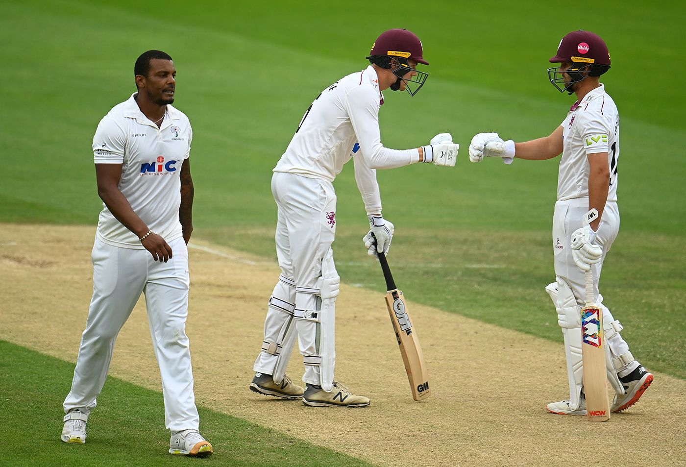 Kasey Aldridge and Lewis Gregory fist-bump as Shannon Gabriel walks back to his mark