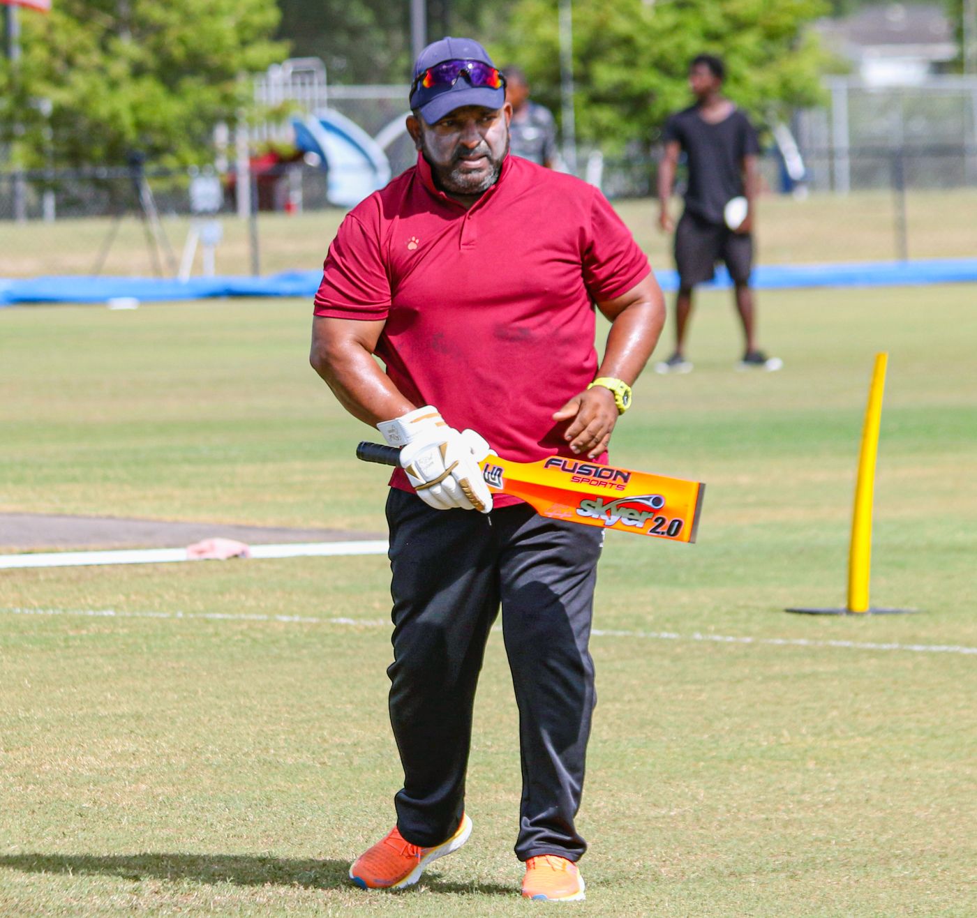 Nepal head coach Pubudu Dassanayake hits catches during pregame warmups