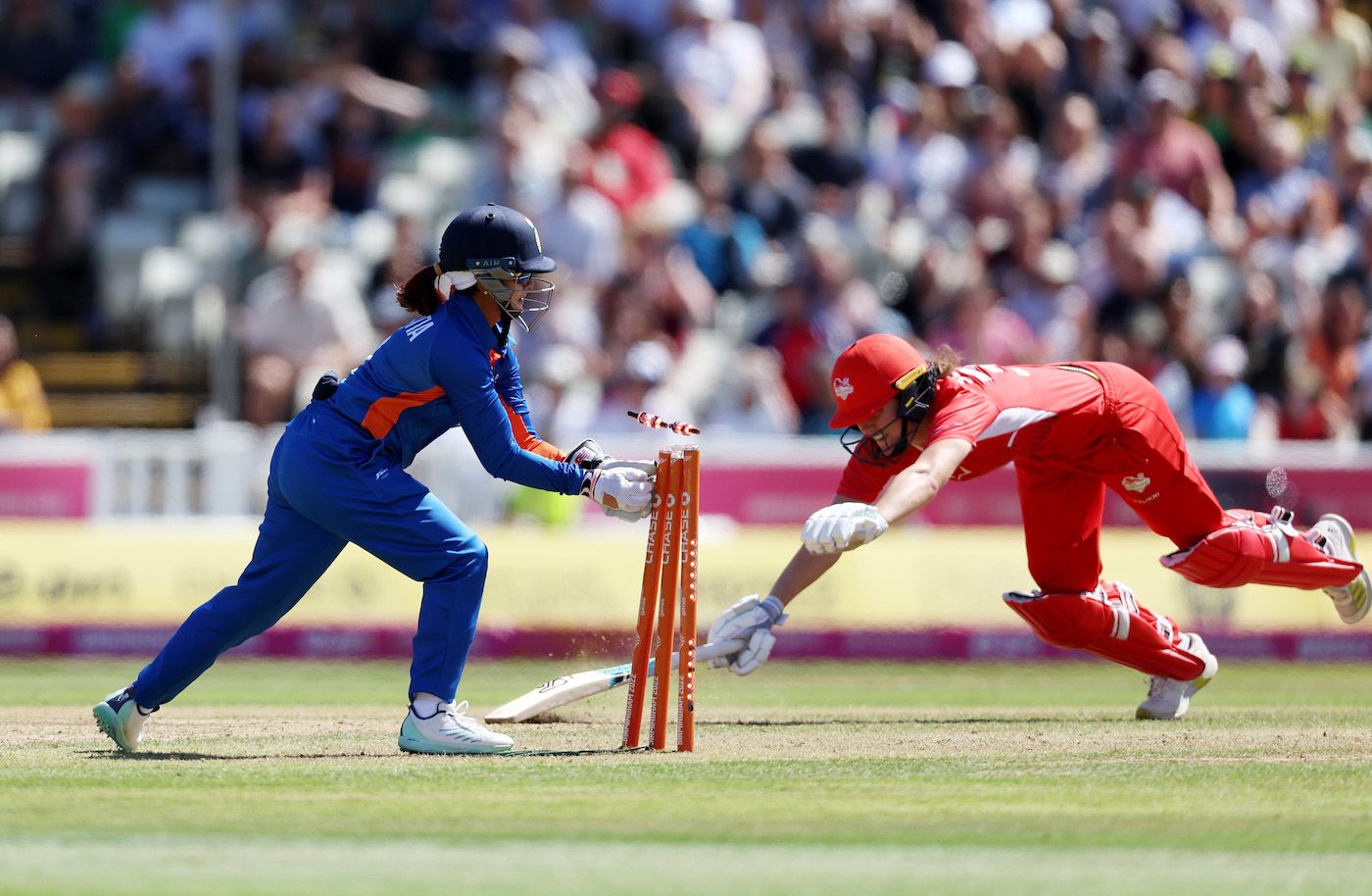 Taniya Bhatia breaks the stumps to catch a diving Nat Sciver short