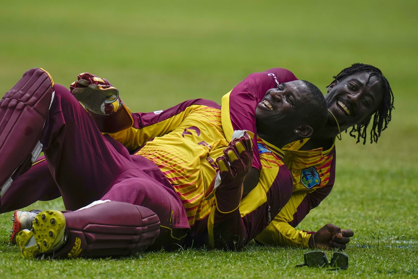 Hayden Walsh embraces Devon Thomas after the latter completed a good catch to remove Devon Conway
