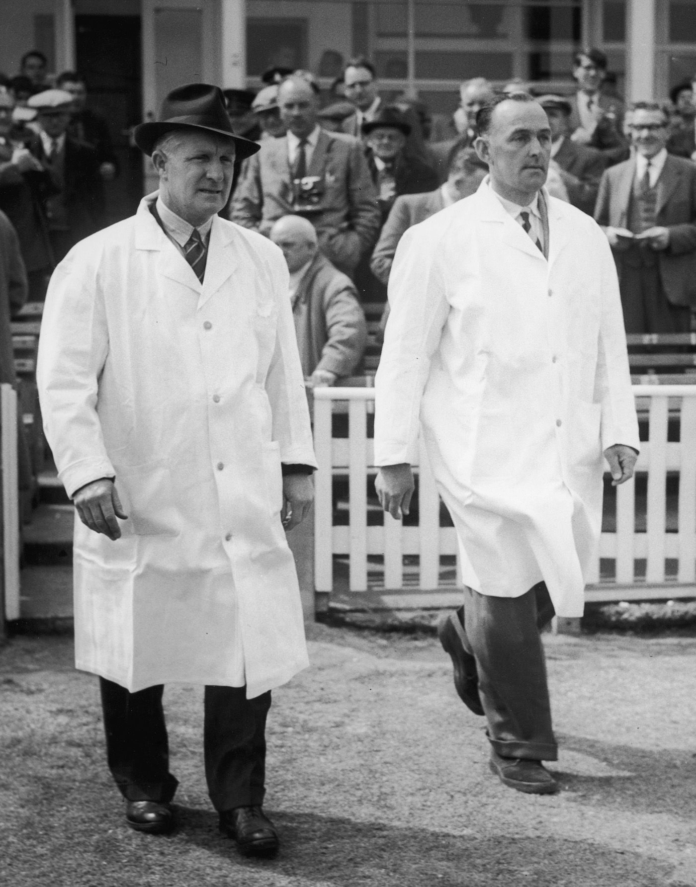 Umpires Emrys Davies and Charlie Elliott walk out on to the field