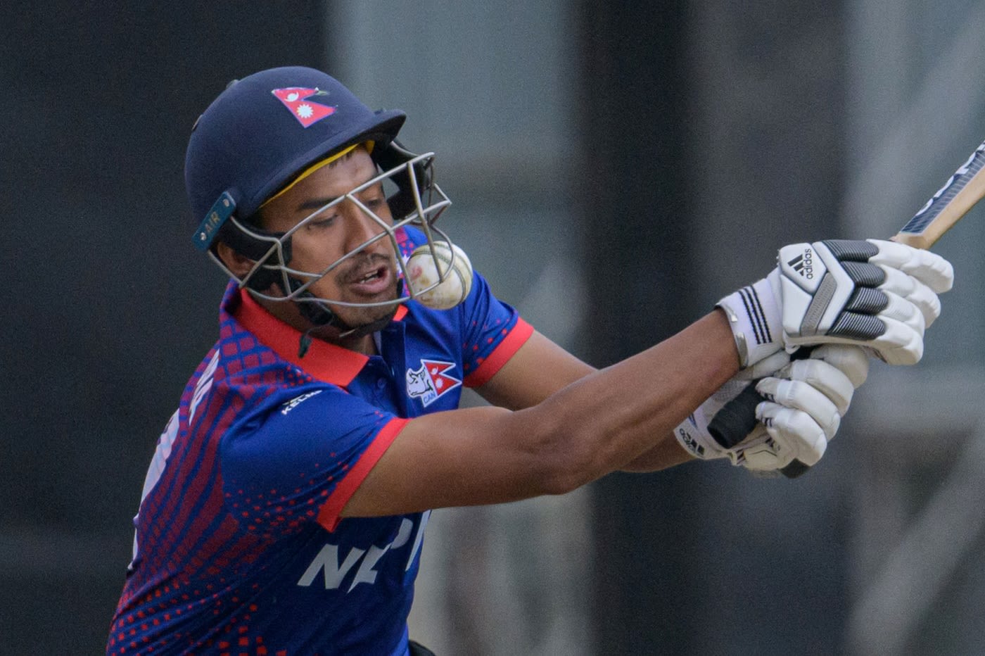 Gyanendra Malla is beaten by one that he plays on to his helmet